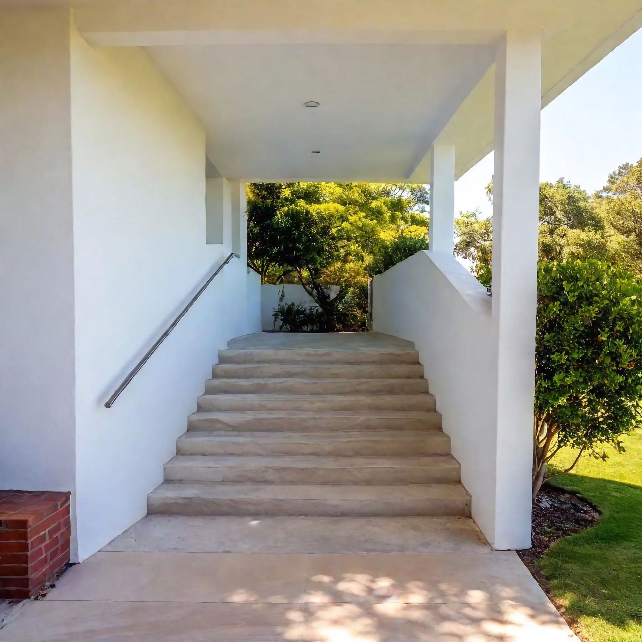 Concrete steps and ramp access to a home entrance